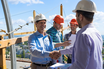 Builders Handshake, Two Happy Smiling Partners Shaking Hand After Meeting With Foreman Team On...