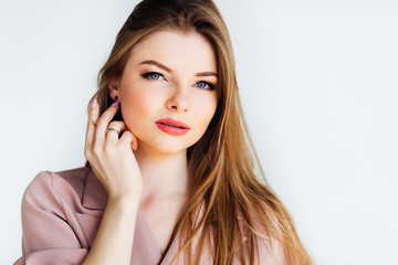 Elegant young blond woman with blue expressive eyes looking at the camera on white background