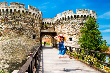 Girl jumping near Belgrade Serbia Castle