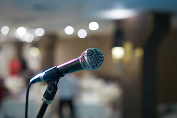 Microphone in concert hall or conference room with defocused bokeh lights in background. Extremely shallow dof. : Vintage style and filtered process