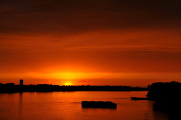 Fototapeta na wymiar Orange sunset over river