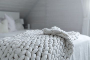 Fototapeta na wymiar White nordic bedroom interior with knit plaid