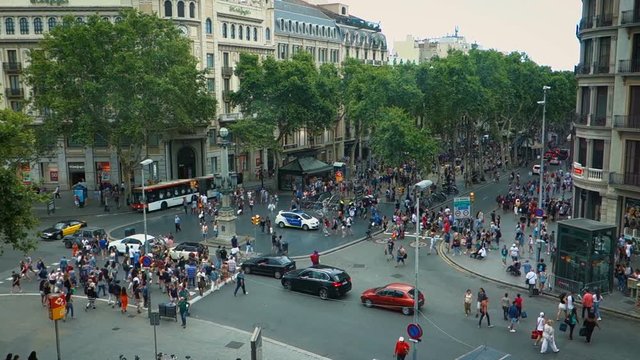 Crowd of anonymous people walking on the Rambla of Barcelona