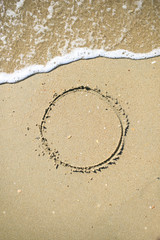 Letter drawn on the sand beach
