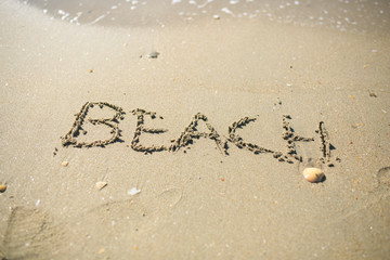 Letter drawn on the sand beach