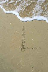 L Letter drawn on the sand beach