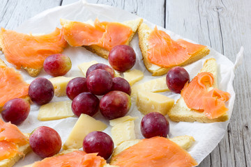 Salmon appetizer with grapes and cheese