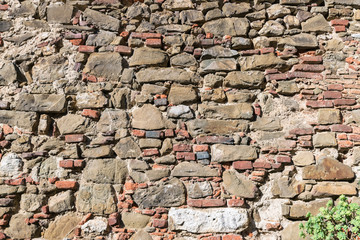 Colored wall made of stone and brick.