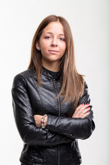 Confident young woman in a leather jacket