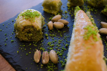 Pistachio and baklava varieties on wooden table