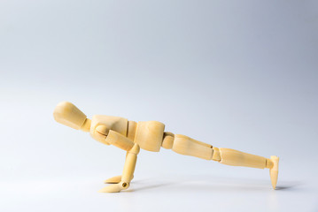 Wooden figure doll with push up for health on white  for exercise training and helth concept