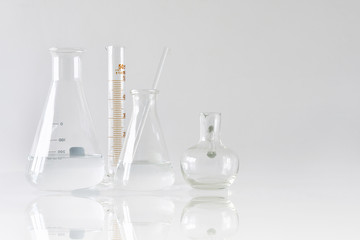Group of scientific laboratory glassware with clear liquid solution, Research and development...
