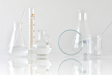 Group of scientific laboratory glassware with clear liquid solution, Research and development...