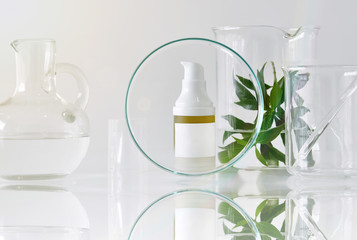 Cosmetic bottle containers with green herbal leaves and scientif