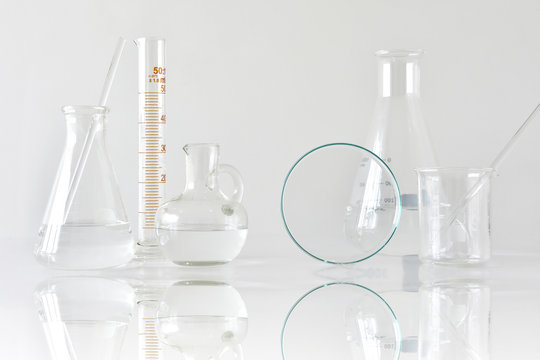 Group of scientific laboratory glassware with clear liquid solution, Research and development concept.