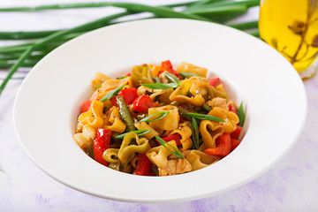 Stir Fry from chicken fillet, green beans and paprika with pasta in the form of heart