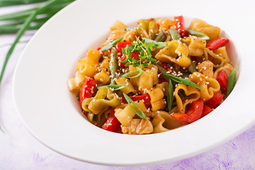 Stir Fry from chicken fillet, green beans and paprika with pasta in the form of heart
