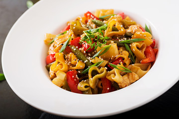 Stir Fry from chicken fillet, green beans and paprika with pasta in the form of heart