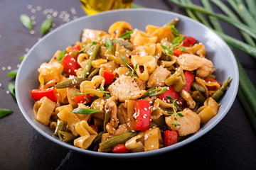 Stir Fry from chicken fillet, green beans and paprika with pasta in the form of heart