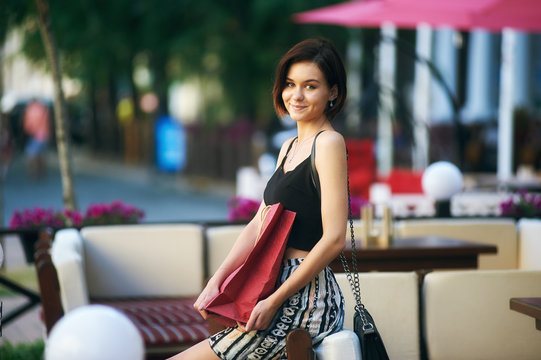 young beautiful girl posing on the street . Model wearing stylish clothes . Urban lifestyle. The concept of fashion and shopping