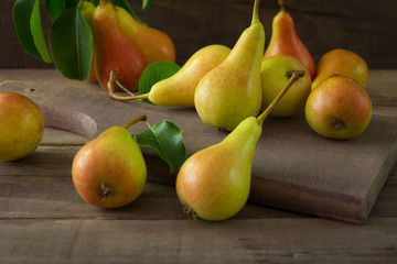 Fresh organic pears on wooden plank