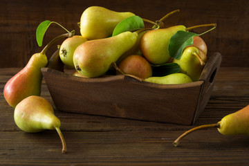 Fresh organic pears in wooden bowl