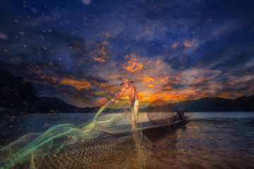 Asia Fishermen on boat fishing at lake with sunset.