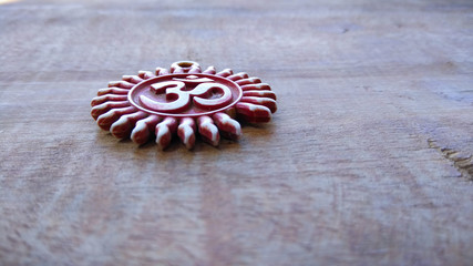 om pendent on wood  background and greeting 