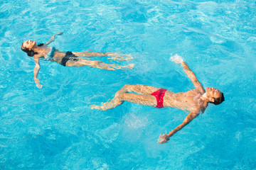 Affectionate couple in swimming pool