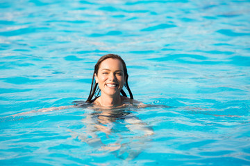 Beautiful woman swimming in the pool