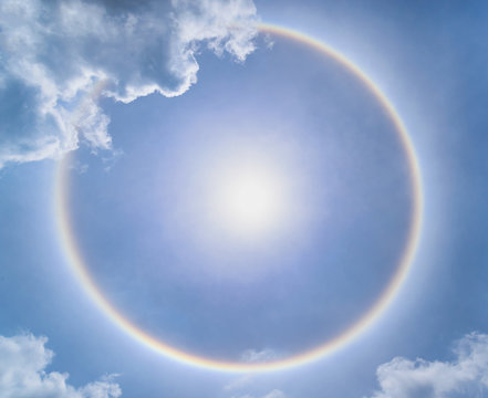 Blur sun halo with cloud in the blue sky.
