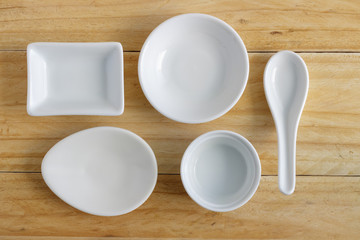 white ceramic ware on wooden table, top view