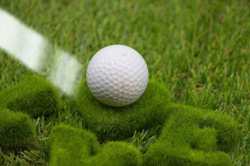 Golf ball is on green grass