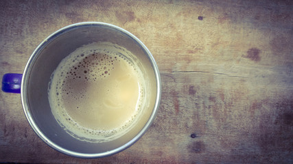coffee in cup on wood background with dark shadow shed