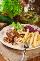 Pork roulade with french fries with salad