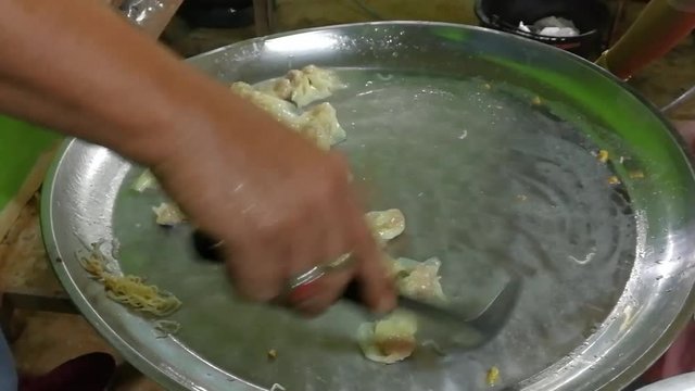 square sheets of wheat dough enclosing mince pork, boiled 