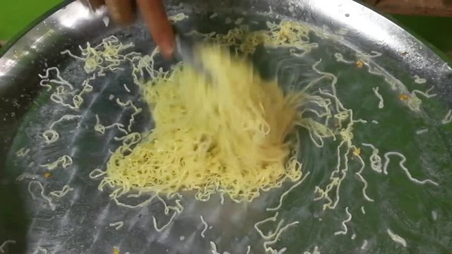 Egg noodles with rice noodles in hot water