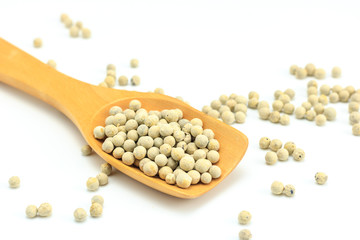 Peppercorn with wooden spoon on white background. Composition isolated over the white background.