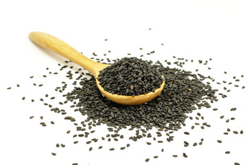 Black Sesame Seeds  with wooden spoon on white background. Composition isolated over the white background.