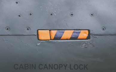 Metal surface from a jet fighter. fuselage of a airplane. with a cabin lock handle