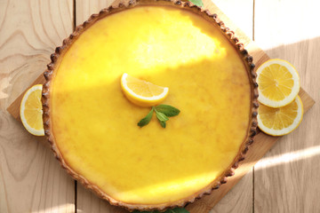 Composition with tasty lemon curd pie on wooden table