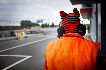 Motorsport track marshall orange racing bib close up with out