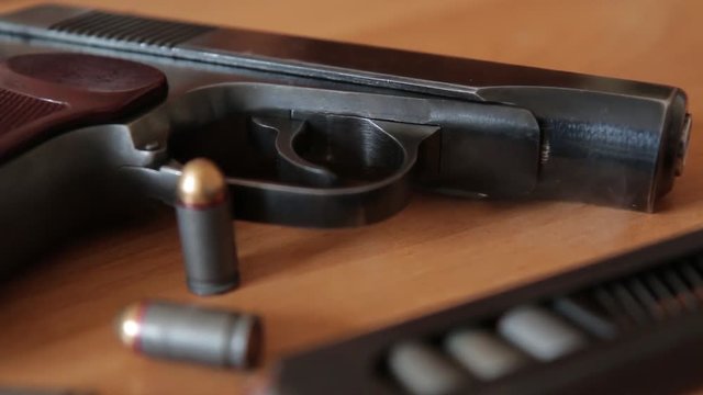 russian 9mm handgun PM Makarov on the table with holster, belt and empty pistol holder