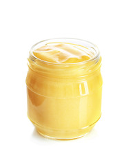Glass jar with yummy lemon curd on white background