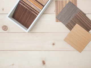 Naklejka na ściany i meble Samples of veneer wood on woodenbackground. interior design select material for idea.