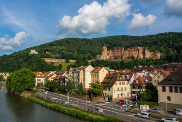 Fototapeta na wymiar HEIDELBERG, GERMANY - JUNE 4, 2017: Panoramic view of Heidelberg castle over the tile roofs of old town from Carl Theodor bridge, Heidelberg, Germany.