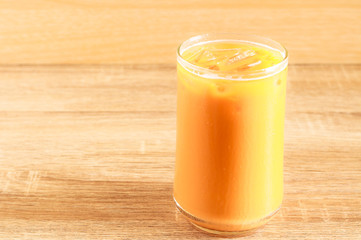 glass of iced milk tea on a table.