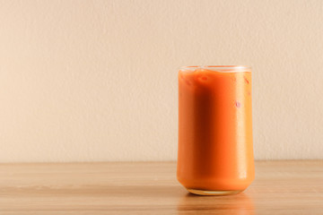 glass of iced milk tea on a table.