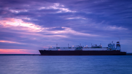 GAS CARRIR AT SUNRISE - Morning on the moored big ship to the waterfront
