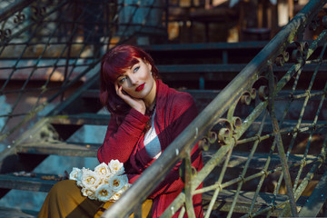 Girl sitting on old house stairs